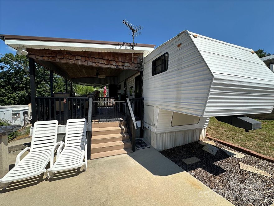 Nice 5th wheel camper on a deeded lot, fully furnished and ready to enjoy. Features a spacious layout with a large bedroom on one end and a bunkroom on the other, plus kitchen, dining, and living areas in the center. Step outside to a covered deck with great lake views. The property includes a brand-new concrete driveway and a sidewalk that wraps around to the back building—golf cart accessible all the way. Located inside the gated community of Badin Shores Resort on Badin Lake. Resort amenities include lake access, pool, marina, beach, playground, restaurant, putt putt, basketball courts, and paved roads throughout.