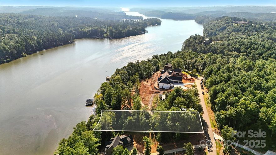 DOCKABLE waterfront lot. Gated community with city WATER and SEWER.  102 feet of lake frontage.    This lot has a generous flat building space with long range lake views and long range mountain views.  Lake Rhodhiss is ideal for fishing, boating, water skiing, wakeboarding, paddle boarding, swimming, kayaking, canoeing; Community recreation area and community lake access are right around the corner.  Underground utilities.