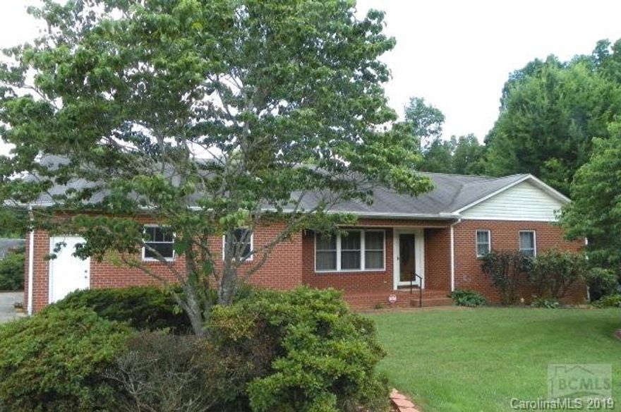 Custom-built Brick Ranch with full basement feature three bedrooms, two bathrooms, and two half-baths (one in basement). Great Room with brick fireplace currently with electric logs; security system.  Large 30' x 50' Masonite siding workshop/building wired with attached 13'2 x 20' shed with storage.