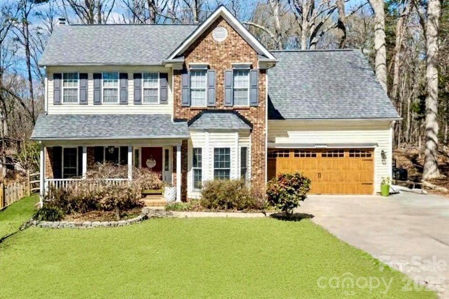 Beautifully updated 2-story home in the sought-after Wiltshire Manor community in Steele Creek. This move-in ready home is filled with thoughtful upgrades and stylish finishes throughout. Enjoy new modern flooring on both levels and stairs, smooth ceilings (popcorn removed), and an expanded driveway for additional parking. The versatile floorplan offers both formal and casual living spaces, including a formal dining room and a formal living room currently used as a main-level office. The spacious family room is filled with natural light and features a cozy, real wood-burning fireplace with a classic white mantel—perfect for gathering and relaxing. The beautifully updated kitchen showcases high-end cabinetry with glass accents, elegant quartz countertops, and flows seamlessly into the breakfast area and family room, making it ideal for entertaining. Upstairs, the primary suite impresses with a cathedral ceiling and a renovated ensuite bath. Three additional generously sized bedrooms each include walk-in closets. The fourth bedroom offers a unique bonus—private access to an upper-level deck with stairs leading to the backyard, creating the perfect guest retreat, office, or flex space. Additional upgrades include newer windows, updated bathrooms, and a stylish garage door. Outdoor living is exceptional with a two-level deck spanning the back of the home, overlooking a truly special backyard. This gardener’s oasis is filled with lush, beautiful plants and flowers that are self-maintaining, along with a greenhouse, shed, charming bridge, and firepit—creating a peaceful, park-like setting with minimal upkeep. Tucked at the end of a quiet street and backing to a wooded natural area, this home offers privacy and tranquility. Enjoy relaxing on the welcoming front porch, perfect for rocking chairs. Conveniently located just minutes from Carowinds, shopping, dining, outlets, I-485, Charlotte Douglas International Airport, and Uptown Charlotte—this home truly has it all!