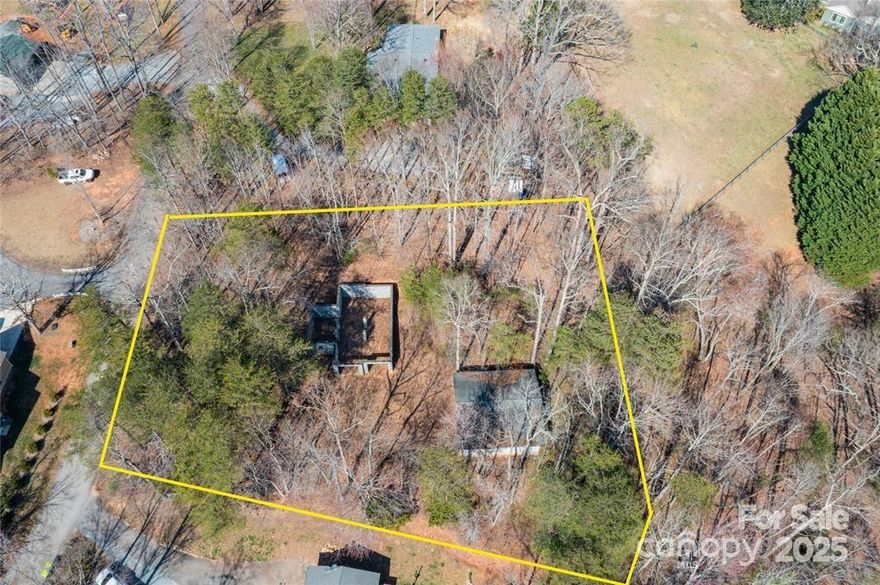 Presenting an exceptional opportunity just moments from downtown Columbus, NC. This unfinished residential building offers the perfect chance to create your dream home. The structure features a 12x16 split rock stone façade, and the construction has been started on a spacious design. The property includes an installed 3-bedroom septic system, city water service, and this neighborhood has access to natural gas. Additionally, there is a large, unfinished two-car garage, offering ample storage or potential workspace. The high-quality basement foundation provides a strong base for continued development, with electrical already on site. Originally designed by Blue Ridge Log Cabins (contact the listing agent for a copy of the blueprint), you can either complete this build as planned or reimagine the space to suit your personal vision. This is a rare opportunity to build a home with exceptional potential in a prime location!