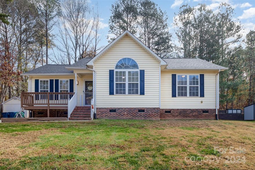 Welcome to this stunning 3-bedroom, 2-bathroom ranch home, filled with updates and charm! From the moment you step inside, you'll be greeted by beautiful hardwood floors that flow throughout, complemented by vaulted ceilings that create an open, airy feel. The spacious kitchen features tile flooring and opens up into the dining and living areas, making it the perfect space for entertaining or family gatherings. The primary suite is a true retreat, with vaulted ceilings, a beautifully tile floor bathroom, and a generous walk-in closet. The two additional bedrooms are equally spacious, providing plenty of room for family, guests, or a home office. Fresh paint and updated lighting throughout give the home a bright, modern feel, making it move-in ready! Outside, the fenced backyard is an entertainer's dream, with a large deck, cozy firepit area, and a handy storage shed. The HVAC was replaced in 2021, the roof in 2023. Just minutes to the nearest Lake Norman public access and no HOA!!