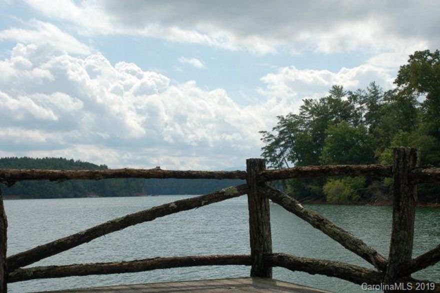 Lot 24 is a gently sloped compound lot with amazing mature trees and is a short distance from Camp Lake James.  Shoreline stabilization and boat dock with boat lift already in place and ready for use.  A long range water view and a private cove view can be had from the building envelope.  The lot size and location, gives this lot that ultimate feeling of privacy and yet still retains that sense of community.  Topography for this lot is a rare find on Lake James.  A gravel drive in allows for easy access from the road and the lot has already been perc tested for a 4 bedroom septic system.  HOA and Camp Lake James dues are $3650 a year.