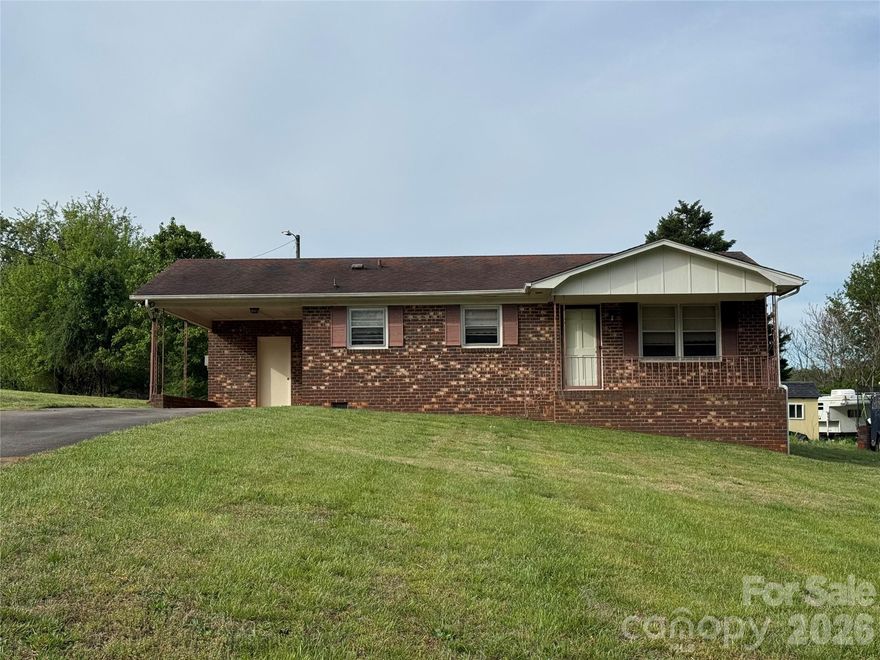 3 bedrooms,1 bath brick ranch in established neighborhood, new carpet, storm windows, single attached carport, utility room, .54 ac lot, make it your own with some fresh paint and updates, priced to sell