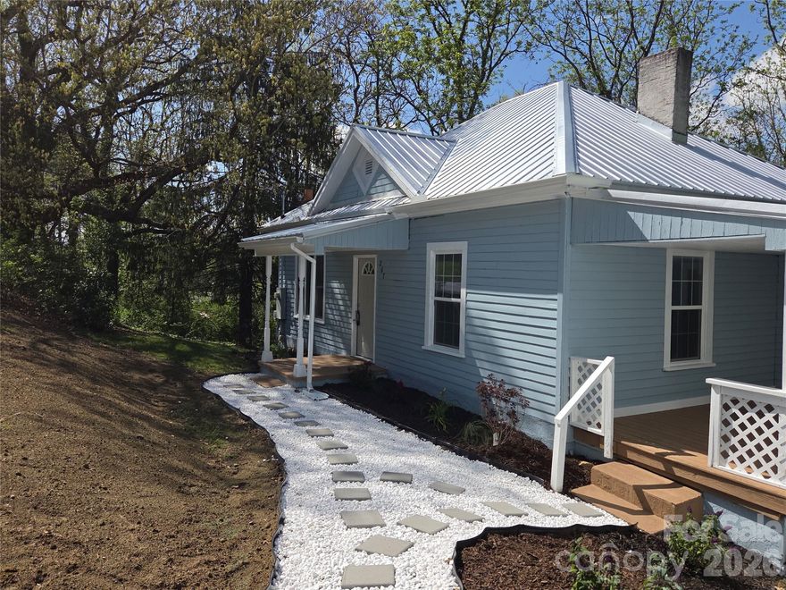 Simply adorable, freshly painted cottage style house in a very convenient area of Canton, very close to Shopping areas and easy access to I-40. This home has been lovingly brought up to date with a  gorgeous new kitchen, complete with brand new stainless steel appliances, butcher block countertops, tiled backsplash and newly installed HVAC. It also boasts a fully remodeled bathroom with porcelain tile custom shower and custom vanity. The brand new stackable washer/dryer is located conveniently right off of the kitchen. The living room features tall ceilings, fresh paint and new light fixtures, along with attic access for future space or existing storage . The primary bedroom offers a half bathroom, and both bedrooms are also newly painted. All the windows have been replaced along with a brand new roof.  There is also a large walk out basement complete with a built in "canning House." Come take a lot at this attractive, mostly flat, usable large lot with easy year round access, car port and plenty of extra parking.