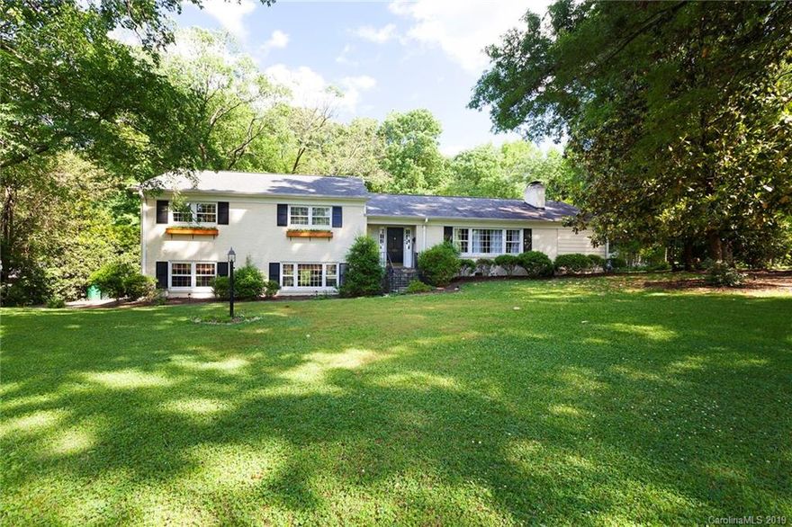 CLASSIC COTSWOLD!!  This Sherwood Forest home has all the stuff of legend.  With a generous 3500+ sq ft on a large lot, you can choose how you want to live in this home. You'll love the traditional elements including a slate pathway, wrought iron railings, dental molding, wainscotting, knotty pine paneling, hardwood floors, gas fireplace, and mature trees. These combine well with the open living space on the main floor, including eucalyptus wood cabinets, granite counter tops, stainless steel appliances, six burner gas range, wall oven plus a microwave/convection wall oven, and wine refrigerator.  The home office is a great space to work or organize your household. The large den has room for family and friends. There is large flex space with wet-bar currently used as a workshop, but previously used as a game room for playing pool. Relax in the comfortable sunroom or on the rear deck overlooking the back yard.  Close to Cotswold, MoRa, Oakhurst, and SouthPark.  See this one soon!