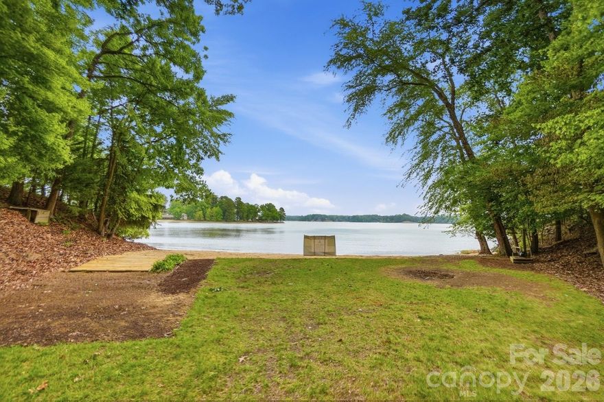 Custom waterfront home on the main channel of Lake Wylie! Enjoy the pristine shoreline with a rare natural sandy beach and firepit, perfect for lakeside entertaining. This property is beautifully landscaped with stone walkways, outdoor cooking station, and multiple picnic areas, all designed to maximize outdoor living. Inside, the home features a primary suite on the main level, formal dining room, and a two-story great room with a stone fireplace. Large windows frame the space while a glass door opens onto a covered porch stretching the length of the home, complete with half-glass panels for unobstructed panoramic lake views. The large unfinished basement offers endless potential, including a garage, recreation area, and abundant storage. Mature trees provide exceptional privacy, and multiple outbuildings offer ideal storage for gardening equipment, lake toys, or hobbies. Whether launching a kayak, gathering around a firepit by the shore, or simply taking in the view from your porch, life on the water invites you to slow down, entertain effortlessly, and enjoy every season! With limited availability and timeless demand, owning on the water isn’t just a lifestyle choice—it’s a smart investment in how you live!
