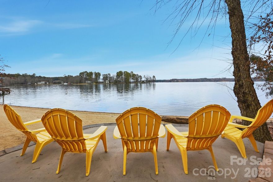 Custom waterfront home on the main channel of Lake Wylie! Enjoy the pristine shoreline with a rare natural sandy beach and firepit, perfect for lakeside entertaining. This property is beautifully landscaped with stone walkways, outdoor cooking station, and multiple picnic areas, all designed to maximize outdoor living. Inside, the home features a primary suite on the main level, formal dining room, and a two-story great room with a stone fireplace. Large windows frame the space while a glass door opens onto a covered porch stretching the length of the home, complete with half-glass panels for unobstructed panoramic lake views. The large unfinished basement offers endless potential, including a garage, recreation area, and abundant storage. Mature trees provide exceptional privacy, and multiple outbuildings offer ideal storage for gardening equipment, lake toys, or hobbies. Whether launching a kayak, gathering around a firepit by the shore, or simply taking in the view from your porch, life on the water invites you to slow down, entertain effortlessly, and enjoy every season! With limited availability and timeless demand, owning on the water isn’t just a lifestyle choice—it’s a smart investment in how you live!