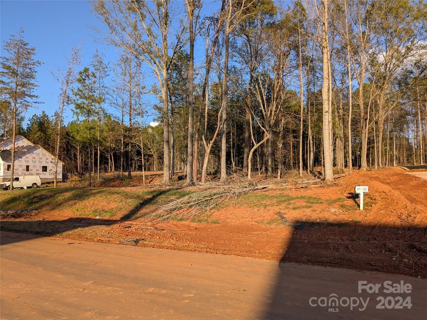 Beautifully wooded lot located on a corner lot of new neighborhood, Heartland Acres. Over one acre of land. Well and septic tank needed. Septic tank permit included. Come check out this residential lot today to build your future dream home on!