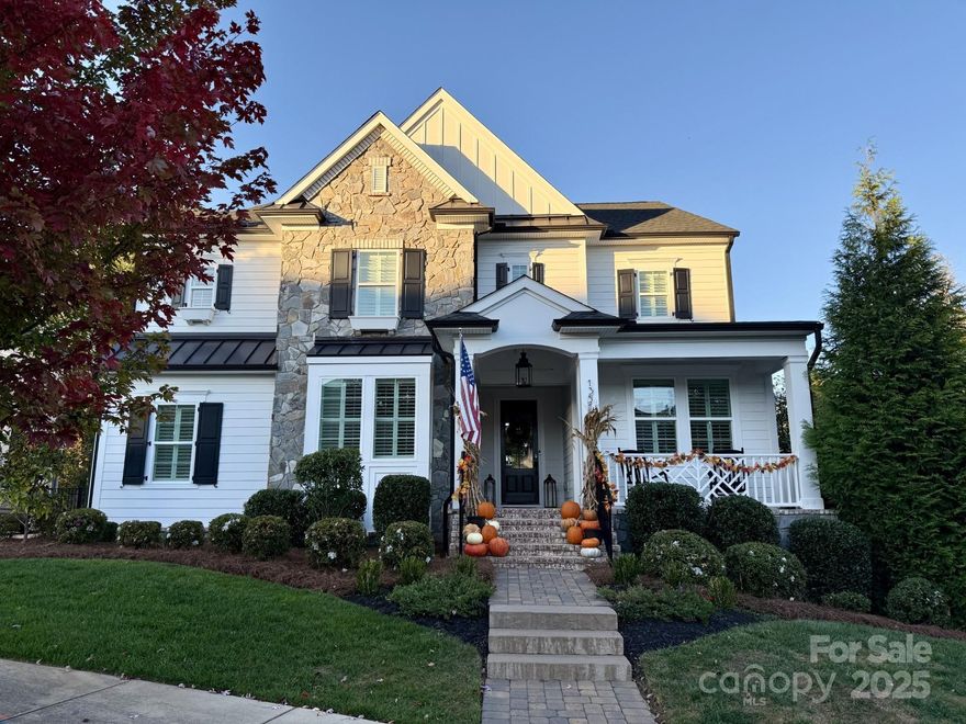 Southern charm meets modern luxury in this Classica Homes masterpiece, featured as the 2025 Better Homes and Gardens Christmas Home. From the moment you arrive, the welcoming front porch and flat driveway set the tone for this warm, elegant retreat. Inside, the office overlooks the porch, offering a peaceful workspace with timeless appeal. The great room impresses with a coffered ceiling, detailed millwork, and a gas fireplace framed by a stunning mantel that is the perfect focal point for gatherings. The open layout connects the great room, dining area, and gourmet kitchen, featuring a huge island, white cabinetry, statement hood, gas range w/pot filler, and an exceptional butler’s pantry with custom cabinetry and generous prep space. The covered rear porch with a stone fireplace provides a private year-round setting for entertaining or relaxing outdoors (Backyard -rear landscaping and woods adjaent land which cannot be developed). Upstairs, the luxurious primary suite offers a spa-inspired bath and spacious closets, conveniently located near additional bedrooms and the loft. The newly finished basement includes a bedroom, full bath, and large open recreation area. Every detail reflects Classica’s thoughtful craftsmanship and the perfect balance of beauty, comfort, and function- A home that welcomes you every single day. Location is minutes away from downtown Huntersville, Birkdale Village and across the street from a beautiful greenway.