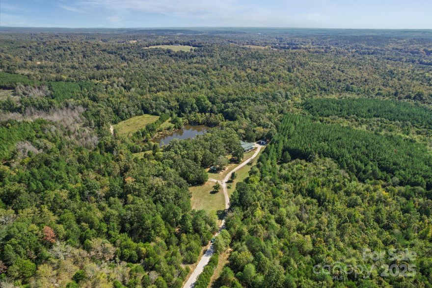 Discover the perfect blend of rustic charm and modern comfort in this stunning lodge-style home, nestled on 82 acres of serene countryside. Surrounded by rolling woods and open pastures, this property is an outdoor enthusiast’s dream, offering endless opportunities for recreation, relaxation, and privacy.
Step inside the lodge and you’ll find soaring ceilings, warm wood finishes, and an inviting open floor plan. The spacious living room features abundant natural light, a stone fireplace, and plenty of space for entertaining. The kitchen is well-appointed with custom cabinetry, and a large island overlooking the living area—perfect for gatherings. The property also includes a loft area, spacious sunroom, and plenty of flexible space to make it your own.
Outdoors, the true magic begins. A well-stocked private pond complete with a dock invites you to fish, kayak, or simply take in the peaceful surroundings. The property is rich with wildlife and natural beauty, while the Broad River is just a short distance away, providing even more options for fishing, paddling, and exploring.
With low property taxes, abundant acreage, and unmatched seclusion, this estate is ideal as a private residence, hunting retreat, family getaway, or investment opportunity.
