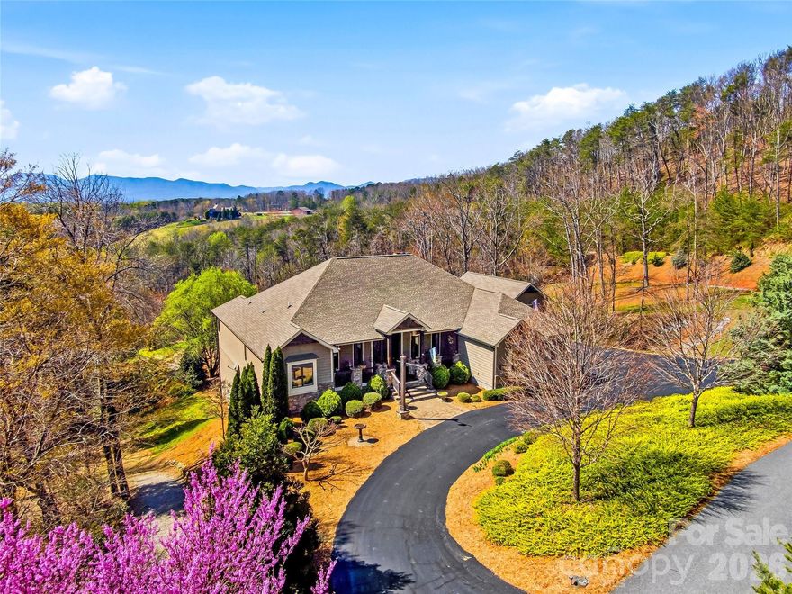 Set within a private gated community on over 6 acres of gently rolling land, this exceptional estate captures the essence of refined country living with breathtaking, year-round mountain views and direct access to the renowned FETA trail system—offering an extensive network of riding trails just beyond your doorstep.

Ideally located just minutes from Landrum, Tryon, and Columbus, and in close proximity to the Tryon International Equestrian Center, this property offers a rare blend of privacy, accessibility, and lifestyle.

A dramatic entry welcomes you into a stunning living room designed to showcase the landscape, where walls of glass frame the mountain views and create an unforgettable first impression.

Just beyond, the great room offers a distinct yet connected gathering space, featuring soaring vaulted ceilings and a floor-to-ceiling stone fireplace. This space flows seamlessly into the gourmet kitchen and out to expansive deck areas—creating an ideal setting for both everyday living and elevated entertaining.

The kitchen is thoughtfully appointed for both functionality and style, featuring a 48" Viking range, complemented by a walk-in pantry and seamless connection to the mudroom and laundry.

The main level offers over 2,700 square feet of thoughtfully designed living space, including a private owner’s suite retreat with radiant heated floors in the spa-inspired bath and a generous walk-in closet. Two additional bedrooms on the main level provide flexibility for guests or a private home office.

The lower level is designed for entertaining and versatility, featuring a custom bar, spacious recreation and billiards area, bonus room, and a full bathroom—ideal for hosting guests, hobbies, or flexible living needs. Direct access to the patio extends the entertaining space outdoors, while abundant storage areas add everyday practicality.

Outdoors, the property unfolds into a private retreat with open grassland, professional landscaping, and a circular driveway that enhances both arrival and functionality. A detached RV barn and additional workshop/barn provide exceptional versatility for storage, hobbies, or equipment.

Located just six minutes from shops, dining, and highway access—with convenient routes to Hendersonville, Greenville/Spartanburg, and both GSP and CLT airports—this estate offers the rare combination of convenience and true mountain living.

An exceptional offering for those seeking space, views, and versatility in one of the region’s most desirable equestrian-access communities.