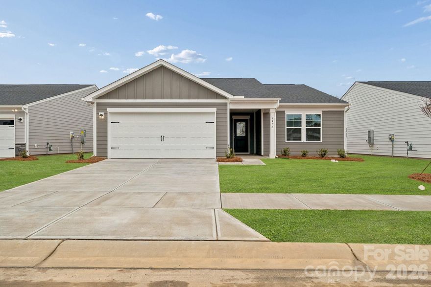 Thoughtfully designed single-level home offering 1,554 sq ft of comfortable, efficient living in a welcoming 55+ community. Nestled on a peaceful lot with serene woods providing natural privacy and a beautiful, wooded backdrop. This inviting 3-bedroom, 2-bathroom residence features a spacious primary suite with a well-appointed bath and ample closet space, plus two additional bedrooms that share a second full bath. The well-designed kitchen centers around a generous island topped with elegant quartz countertops—ideal for meal preparation and casual entertaining. Enjoy modern efficiency with a tankless gas water heater that delivers endless hot water while saving energy. Step outside to the rear patio to savor the tranquil wooded views from your backyard—perfect for morning coffee, relaxing evenings, or simply enjoying the calm surroundings. Low-maintenance one-level living meets timeless comfort on this special wooded homesite. Schedule your tour today!