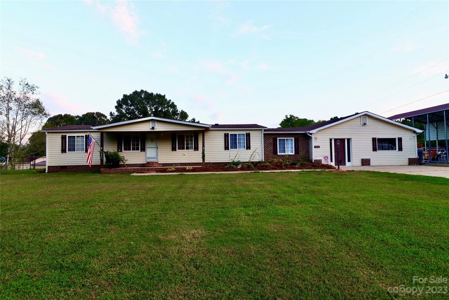 Nestled on a sprawling 3.5-acre fenced lot, this charming manufactured home offers the perfect blend of comfort, space, and outdoor living. As you step inside, you'll be greeted by a spacious and inviting interior, including a flex room ideal for a home office or entertainment space. Pamper your furry friends in the dedicated dog grooming room, ensuring they're always looking their best. Step outside onto the large covered back deck, where you can relax, entertain, and enjoy the serene views of your private oasis. A rocking chair front porch adds to the home's Southern charm, providing the perfect spot to savor your morning coffee or watch the sunset. For those with outdoor hobbies or livestock, there's a barn on the property. RV enthusiasts will appreciate the convenience of RV hookups with a covered awning, making it easy to accommodate guests . This property truly offers the best of both worlds, combining comfortable indoor living with extensive outdoor amenities.