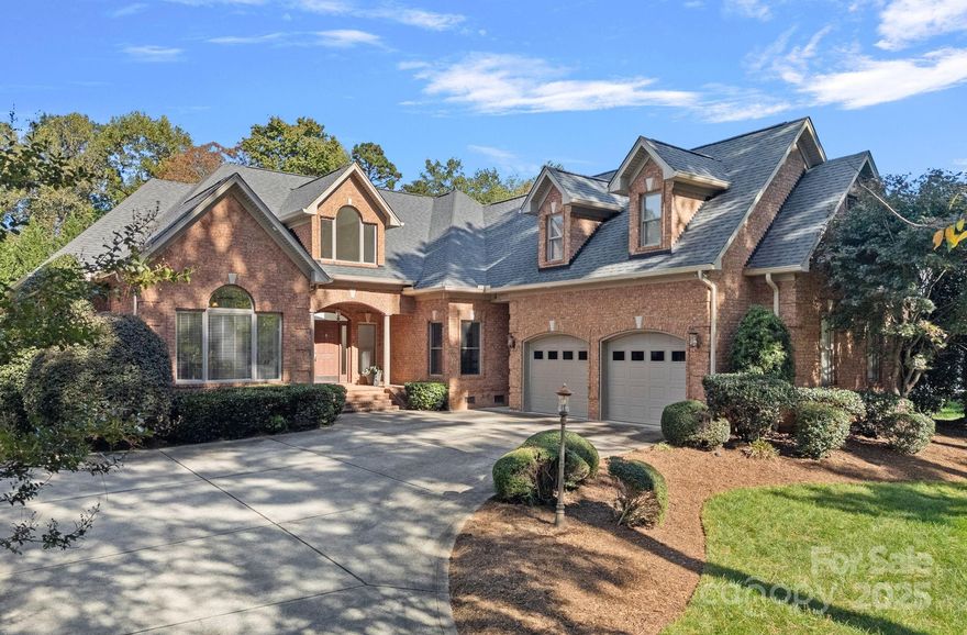 Welcome to this elegant, full-brick estate, nestled in a serene, park-like setting within the desirable Wildwood Cove community. This retreat offers the best of both worlds: peacefully situated between Mooresville and Troutman, yet just minutes from vibrant shopping and dining options. Step inside the bright, open entry foyer, where abundant natural light and soaring ceilings create an immediate sense of grandeur. Discover a  ophisticated design characterized by trey ceilings and a practical split-bedroom floor plan on the main level. The expansive primary bedroom is a true sanctuary, featuring a large en-suite bath for ultimate relaxation and peaceful views of the nearly 1-acre backyard. Main-level convenience is key, with a large laundry room, a private office, and two additional bedrooms sharing a full bathroom. The heart of the home is the gourmet kitchen, boasting granite countertops and rich cabinetry. A charming breakfast or sitting area sits just off the kitchen, offering continuous, peaceful views of the lush, park-like backyard. Step outside to the covered back patio, the perfect venue for outdoor entertaining or quiet relaxation amid the meticulously maintained grounds. The upper level expands the living space dramatically. It includes a media room, a full bathroom, and two large bonus rooms, offering endless possibilities as a home gym, hobby space, or secondary living areas. A fantastic bonus for water enthusiasts: a deeded boat slip is just a short walk or drive away, providing easy access to the lake. This home beautifully balances sophistication, comfort, and the alluring lakeside lifestyle.