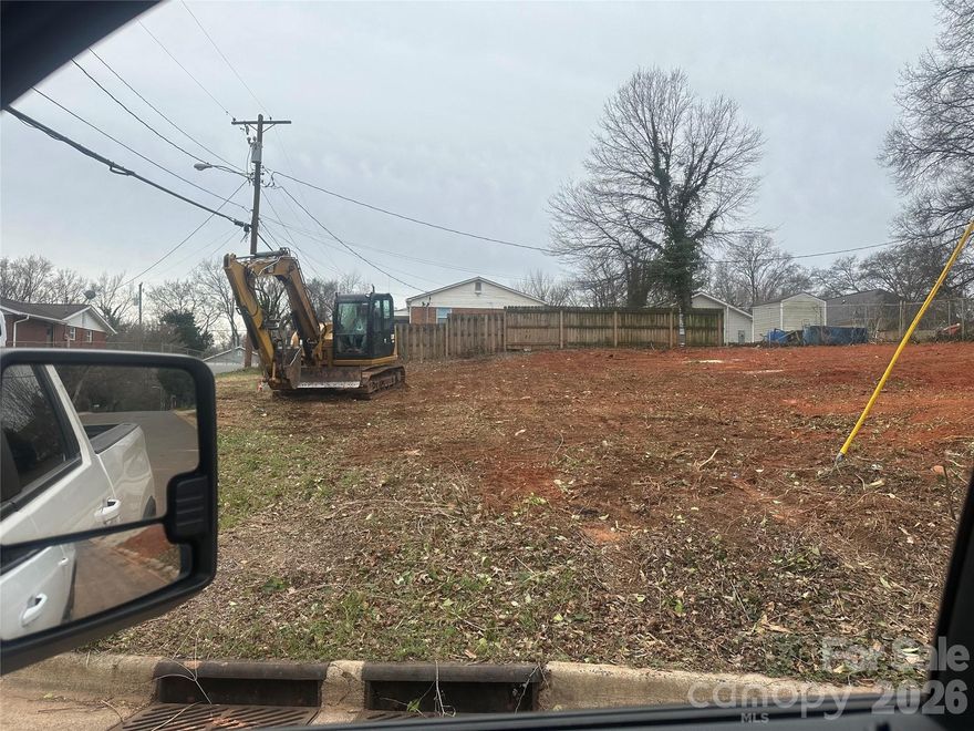 Shovel ready vacant corner lot in West Charlotte, minutes from South End and Uptown. Clearing and grading has already been completed allowing a buyer to move directly into construction without delay, providing significant upfront cost and time savings. Public water and sewer are available at the street, and the lot features fairly flat topography suitable a slab foundation, ideal for a smooth and efficient build. The surrounding area continues to see strong growth, with new construction homes in the neighborhood selling for $400k+. Excellent opportunity for a builder, investor, or first-time ground-up project.