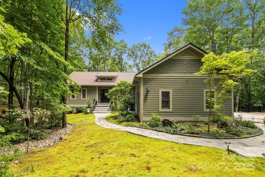 Enjoy the privacy of this 2+ acre cul-de-sac, level lot in prestigious Connestee Falls.  Close to the east gate entrance and the countless amenities offered, this open and light filled home offers all the luxury and comfort of new construction.  Recent updates include HVAC, roof, driveway, decking and all baths with granite and tile finishes.  The spectacular sunroom offers a quiet space to read, surrounded by nature,  wooded views from all rooms add to the peace and tranquility while the extensive hardwoods, vaulted ceiling with skylights, cozy fireplace, natural light, expansive decking and outdoor eating area, and chef's kitchen add to this most welcoming and comfortable of homes.  The walk-in pantry, large laundry room, and oversized garage with workshop space and sealed floor all add to the main level ease of household chores.  The lower level family room walks out to a second expansive deck and seating area and the storage space handles all your holiday decorations and keepsakes.