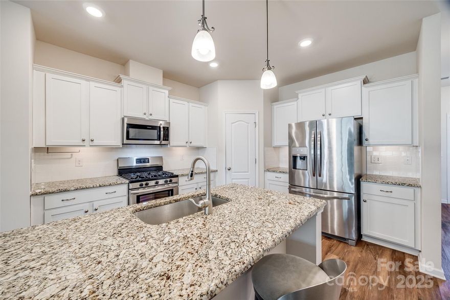 Pool Season is coming and this townhome offers a prime location perched up and overlooking the community pool and amenities. Featuring the popular Morgan floorplan in The Greens, this layout offers an ideal bright and sunny first floor office with glass french doors, a perfect work from home space.  The main level is an open concept with the kitchen flowing to the dining space & great room. Beautiful neutral colors throughout with white kitchen cabinets, granite countertops, under cabinet lighting, & SS appliances including the refrigerator! As you head upstairs, the spacious primary suite has a large walk-in closet, & a separate tub and shower.   Head out to the back yard space and enjoy relaxing on the rear deck space, perfect for Spring nights by the fire. Home is equipped with whole home Wi-Fi, Honeywell smart thermostats, & security.
Don't miss Townhome living with this great location & so much convenience being right across from the Promenade at Carolina Reserve Shopping Center.