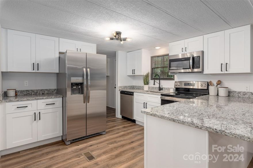 SELLER IS OFFERING BUYER CONCESSIONS with a competitive offer! Modernized 3 bed, 2 bath ranch in desirable Rock Hill situated on nearly half an acre! This home showcases an open concept, split floor plan with an abundance of updates. Shows like NEW— Upgraded LVP/carpet, fresh paint, modernized kitchen & baths with sleek black light fixtures throughout. Eat-in kitchen presents white shaker cabinets, granite countertops & SS appliances. Family room highlights a focal point gas fireplace & sloped ceilings making the space feel even larger! Primary bedroom complete with an upgraded ensuite bathroom. Secondary bedrooms are privately located on the opposite side of the home sharing their own fully updated bath. Entertaining space extends outdoors to the back deck overlooking the spacious, tree-lined lot! NEW HVAC system 2023 & NEW roof 2024! Just minutes from I-77 making for an easy commute— Less than 40 min to bustling uptown Charlotte! Perfect for first time buyers!