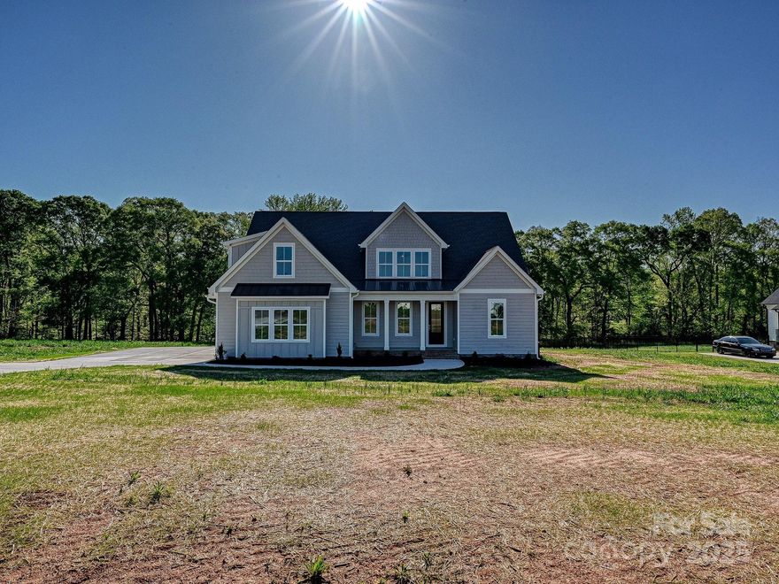 Charming, Modern farmhouse-style home located within one of Clover's newest high-end communities, Edmunds Farm! This one comes equipped with all the "wow" features: A grand two-story great room; Expansive, picture windows that allow in loads of natural light; A dreamy kitchen loaded with cabinetry, and eat-in area, and a massive pantry w/ darling glass wooden doors; Downstairs Flex room would be perfect as a formal dining room, additional living room space, and/or an office; The primary bathroom connects to the laundry room giving it the most functional and glamorous layout; The primary bathroom includes a spacious walk-in shower and freestanding tub; The dreamy primary closet has tons of shelving and its own window to allow natural light to flood in; Real wood floors throughout all main areas--upstairs and downstairs; Upstairs includes two full bathrooms; The porches exude elegance with their tongue and groove ceilings; A wood line borders the back yard, giving you ultimate privacy!