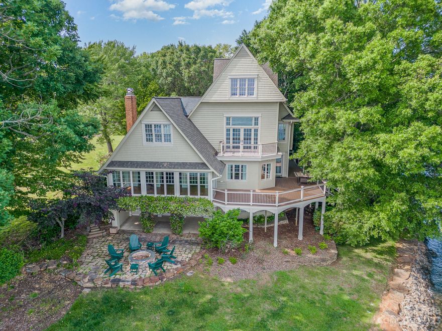 One of the very best lots north of HWY 150 Bridge, this magnificent home is captivating! Sitting high on the point of a peninsula, the southern LKN exposure provides panoramic views for this stately home. Custom built, totally renovated in 2002. Fabulous floor plan makes large home warm & inviting. Newer kitchen w/Thermador & Sub-Zero, custom cabinets, granite counters & spacious island. Wide plank antique heart of pine floors on main & some leaded glass windows. Bar area for entertaining. Sunroom w/incredible views, PB w/private balcony. Multiple large deck areas, all w/incredible views. Additional finished 525 sqft heated & cooled space over detached garage gives tons of flex space. Home has lots of storage & great space for lake toys. Totally renovated pier in 2014. Covered boat slip w/lift, gazebo, composite decking, 2 jet ski ports. Deep water year round! Market 18B in front of house. Landscaping on lot is breathtaking. Plenty of parking. A very special property you need to see!