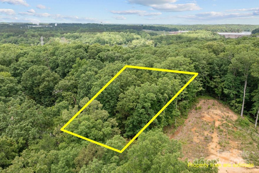 Scenic wooded lot located just minutes from Mountain Island Lake, with easy access to the interstate and nearby dining options. Imagine your dream home here, waiting to be built!