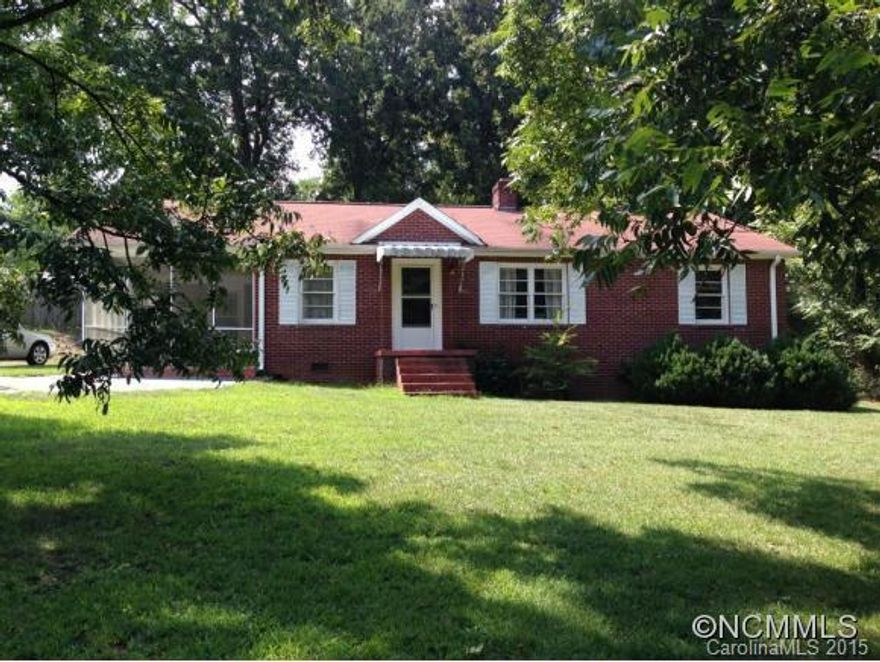 All brick home w/ charm and character and huge pecan trees in front yd. Large LR w/ french doors separating dining room.  Brkfst area in kitchen, den w/ pine walls. Wall mounted propane gas heater provides back up heat if needed.  No carpet in this home, hardwood floors in all rooms except kitchen and den (owners say there may be HW floors under vinyl).  Inside stairs provide access to the partial basement, stairs to outside. FP in basement.