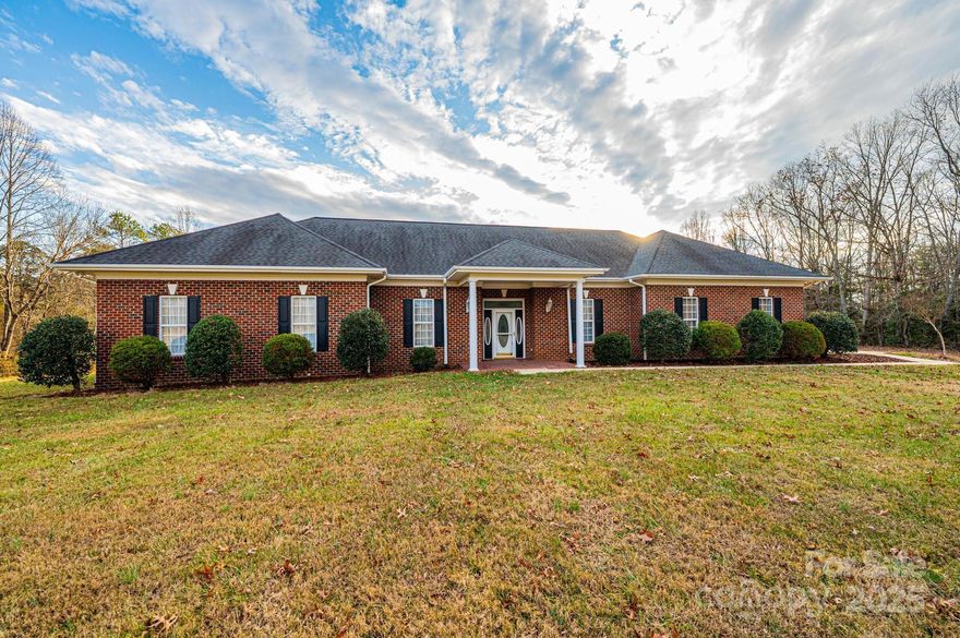 Welcome to this beautifully designed, one-level brick ranch, perfectly situated on a little over 9 acres and offering peaceful, wide-open views of the surrounding farmland. With soaring 10-foot ceilings and a thoughtfully crafted layout, this home provides exceptional comfort, natural light, and effortless flow throughout. The foyer sets the tone as it opens into a spacious great room, creating a warm and inviting atmosphere from the moment you enter. Just beyond, an additional den and full guest bath provides extra space for relaxation or casual gatherings. A bright, airy sunroom extends the living area even further, filling the home with natural light and offering the perfect spot to enjoy the serene views around the property. At the front of the home, you’ll find a formal dining room ideal for hosting, along with a versatile flex room that can serve as a home office, study or library. A well-designed kitchen boasts exceptional storage and efficient layout for everyday cooking. The generous primary bedroom offers a private retreat with a large en-suite bathroom and a walk-in closet. The two additional oversized bedrooms also include walk-in closets and a shared jack and jill bathroom. Adding tremendous value and versatility is the second living quarters, providing an excellent opportunity for multigenerational living, guest accommodations, or a private suite for extended stays. Completing the property is a spacious 3-car garage. Set on over 9 acres of quiet, picturesque land, this property delivers the rare combination of expansive indoor living and breathtaking outdoor surroundings. Whether you’re looking for privacy, space to explore, or a home that embraces the beauty of its natural setting, this one-level ranch offers it all. Priced below recently appraised value!