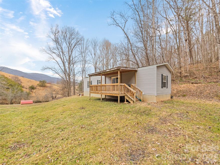 This property checks both lifestyle and investment boxes, offering over 6 acres across two unrestricted parcels in a peaceful pastoral setting. The 2019 single-wide manufactured home features 2 bedrooms and 2 bathrooms, perfect for immediate use while you explore future opportunities. Two additional house pads and two additional septic tanks allow for expansion, rentals, or multigenerational living. A small pond enhances the privacy, with only one neighboring home beyond the property. Enjoy easy year-round access and potential long-range mountain views — a rare and versatile mountain opportunity.