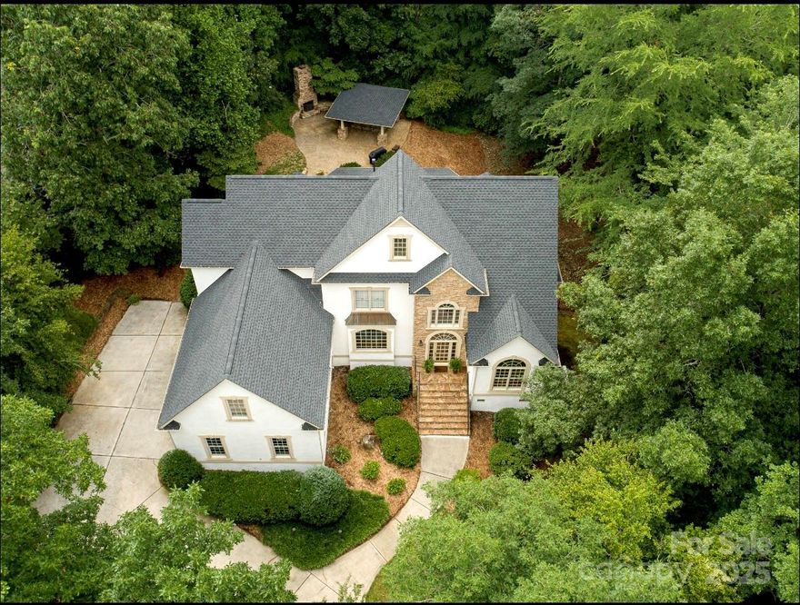 Situated on a beautifully landscaped lot offering exceptional privacy. NEW ROOF, updated designer inspired exterior paint color,  new carpet, and completed cosmetic stucco work for worry-free living. Discover exceptional value in the prestigious Firethorne County Club community, zoned for top-rated Marvin Ridge schools! Step outside through the family room double doors to enjoy the large covered porch, cabana with a bar, and stone fireplace—perfect for entertaining. Primary on main, 3 secondary bedrooms up and a versatile bonus room. Unfinished 787 sqft basement with exterior access.  The sealed basement with a brand-new dehumidifier adds efficiency and peace of mind. Amenities: Golf, pools, fitness center, sport courts, club house. This sought-after community offers world class amenities and an exceptional lifestyle.