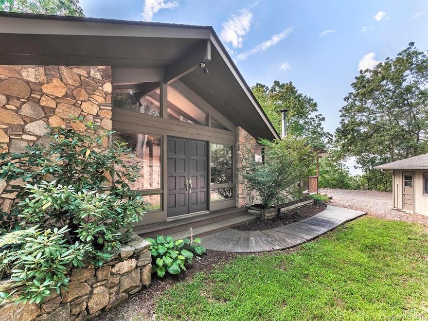 Mid-century custom home w/massive windows, completely surrounded by nature.  Beautiful, long-range views of town and the surrounding mountains while relaxing in front of a fire, enjoying breakfast or unwinding after a long day.  This home offers outdoor living, storage, a spacious workshop.  Convenient seclusion.  Lower level kitchen & living area.  No septic records found.