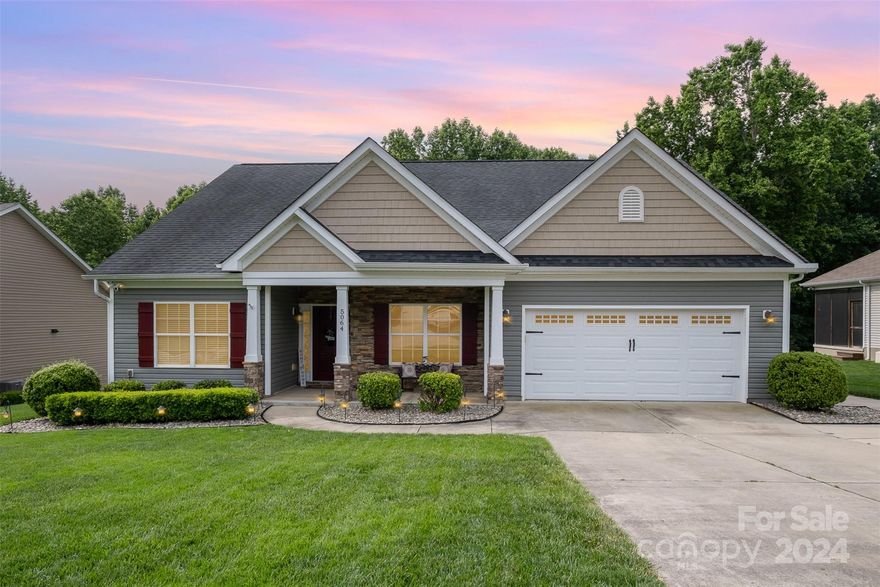 Come view this immaculate 3-bedroom and 2.5-bathroom ranch home located in the highly desirable Abbington Woods subdivision in Belmont.  As you pull up to this home, you will notice a covered front porch, two-car garage, and well-maintained yard.  This home boasts a split bedroom floor plan with a large open area for the kitchen, dining area, and living room.  The large windows throughout the home allow for natural light to fill the home.  The kitchen comes fully equipped with stainless steel appliances, a lovely backsplash, and a breakfast bar.  The master bedroom comes with a walk-in closet and a large bathroom with a garden tub, shower, and private water closet.
The covered back porch offers a serene escape and a lovely view of the large fenced-in backyard that is nestled against the woods.  Seller is offering a one year home warranty and the refrigerator in the kitchen if desired.