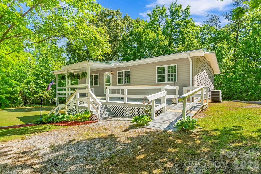 New listing! First time ever offered, this lovingly maintained home delivers the rare mix of privacy, practicality, and value that buyers are always hoping to find.

Set on a mostly flat parcel that feels wonderfully tucked away while still being close to town, this two-bedroom, one-bath home offers 1,239 square feet of clean, comfortable living space. The care here is obvious at every turn. Updates completed in 2013 include windows, vinyl siding, granite countertops, and cabinets, while a metal roof was added in 2019 for extra peace of mind. Inside, gas logs add a warm, welcoming touch that makes the living area feel instantly inviting.

Outdoor living is a standout feature, thanks to the wraparound covered porch that is just waiting for rocking chairs, morning coffee, and long conversations. The lower level with rock exterior adds character and useful basement space for storage, hobbies, or easily finished out for additional living space.

Need parking, workshop space, or room for an excessive amount toys? This property understood the assignment. A 30 x 50 outbuilding with12-foot ceilings includes two 12 x 10 garage doors, an office door, concrete floor, insulation, electricity, and gas heat on a thermostat. A second building with electricity, previously used as a bass boat shed, adds even more flexibility.

With Lake James and the Fonta Flora State Trail nearby, this immaculate original-owner home is a special find. Come see it in person and make your move before someone else does.