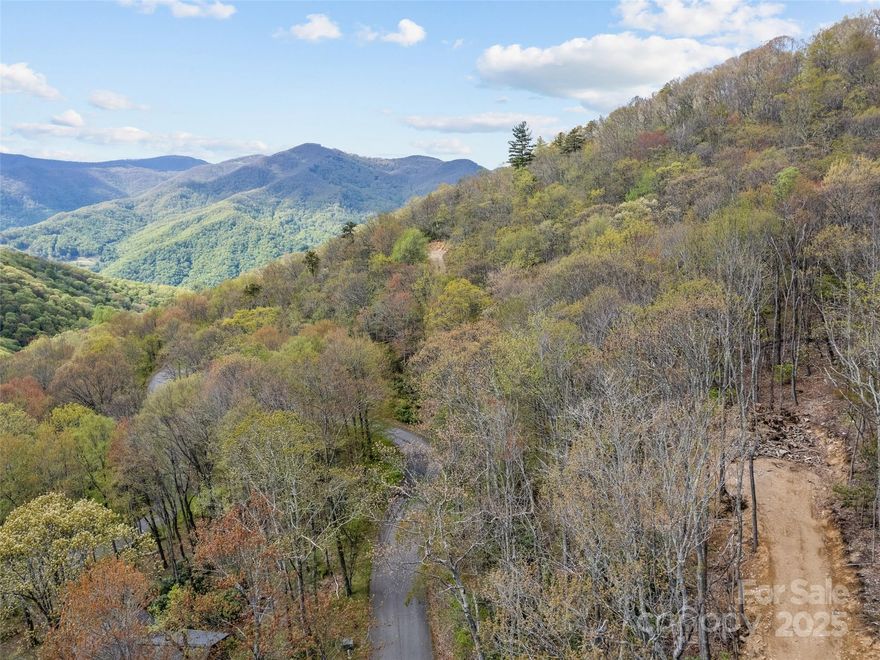 Outstanding views on this 1.93 acre lot. Located in the 1,000 acre gated Smoky Mountain Retreat at Eagle's Nest, Maggie Valley. Driveway and building pad roughed in. City water, underground utilities. Easy to build on.