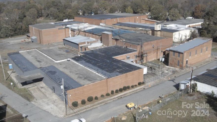 The historic Cherryville Mill offers over 152,000+- square feet of space on a 4.97-acre lot with over 996 feet of road frontage and approved RMF zoning. The property presents an exciting opportunity for redevelopment into apartments, townhomes, or mixed-use residential space and would make an excellent subject for a 1031 exchange. Both the city of Cherryville and Gaston County are eager to see this property repurposed and have voiced strong support for redevelopment. The mill retains much of its original character, with exposed brick walls, large wooden beams, and soaring ceilings that would add character and appeal to any redevelopment project. Its strategic location just 0.4 miles from the developing downtown of Cherryville, places it at the center of a thriving area with several major housing projects underway. Cherryville is set to experience significant economic growth, partly driven by a slated lithium mine expected to create thousands of new jobs.
