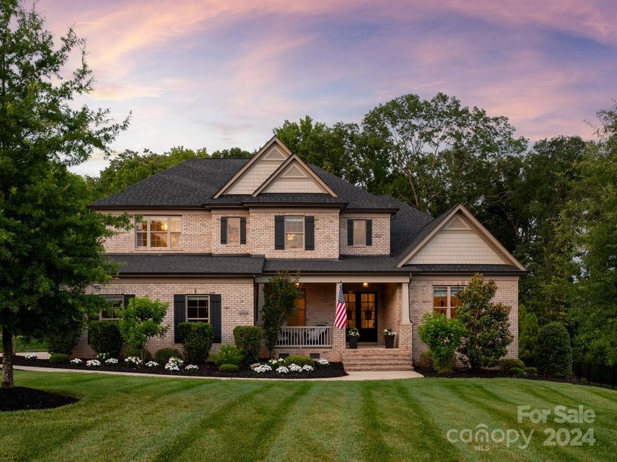 Newer home in Marvin community w/ both a primary on main + additional guest suite, located on .79 acre cul de sac lot within walking distance to community amenities. Interior features a 2 story foyer & 13 ft ceilings in the dining room. 7 inch hardwood floors throughout all main areas + designer lighting & neutral paint. Great Room features 16 ft double slider doors, gas fireplace & custom built ins. Kitchen includes a 5 burner gas cooktop, built in Monogram Fridge & walk in pantry! Lovely primary suite w/ hardwood floors & luxury bath + oversized his & her walk in closets. Upstairs you will find 3 additional secondary rooms each w/ a walk in closet, 2 full baths & a bonus room. Enjoy the weather & take in the views of the private backyard on the covered porch. Backyard also features a lovely paver patio, built in grill plus gas firepit. Other features include an EV charger in the garage, custom drop zone w/ built in cabinets, central vac & full irrigation. Zoned for Marvin schools.