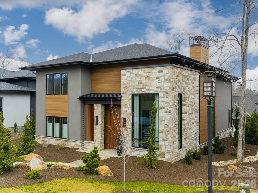 Experience elevated mountain living in The Cliffs of Walnut Cove!  This striking modern luxury home, with stunning long-range mountain views, is designed with clean architectural lines, natural stone and warm wood accents, creating an impressive first impression. Inside, custom Schüco windows and Raynaers European doors fill the home with natural light and seamlessly connect indoor and outdoor living spaces. The open-concept living area centers around a soaring gas fireplace, while the chef’s kitchen features Cristallo Quartzite countertops, premium Thermador appliances, and sleek modern finishes and lighting. Outdoor living is equally impressive with a screened covered patio featuring a natural stone fireplace and large sliding doors for seamlessly accessible entertaining. Above it all, a one-of-a-kind rooftop sundeck offers breathtaking long-range mountain views, creating an unforgettable setting for sunset gatherings in the Blue Ridge Mountains. The spacious primary suite is a luxurious retreat featuring a hand-painted accent wall and a spa-like bath with heated floors and walk-in triple head shower. All bedrooms are ensuites, and thoughtful details include large closets with accent lighting and custom built-ins. Additionally, the home features high-end designer lighting throughout, engineered white oak flooring, an upper-level wet bar, elevator, central vac and a bonus exercise/flex room with mountain views. Also, a large encapsulated, walk-in crawl space with a dehumidifier provides exceptional storage. Located just a short walk from the community’s wellness center, this exceptional home blends modern design, luxury craftsmanship, and breathtaking mountain scenery.  A Cliffs membership is available for purchase. Member residents of The Cliffs at Walnut Cove enjoy access to world class amenities, including a Jack Nicklaus Signature golf course, state-of-the-art wellness center, indoor and outdoor pools, tennis and pickleball courts, and miles of scenic hiking trails. Membership opportunities extend access to all seven Cliffs communities, delivering an unmatched lifestyle experience.