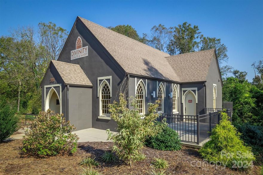 THIS PROPERTY IS AVAILABLE FOR SALE...IT IS LEASED ON A MONTH-TO-MONTH BASIS. Own a piece of Morganton’s history! Originally St. Stephens Episcopal Church, this charming property was thoughtfully renovated in 2021, blending its historical architecture with modern updates. Renovations were for a doughnut shop and included a new roof and HVAC. Kitchen is downstairs, so space was left to add a dumbwaiter. If looking for a restaurant space, enjoy the tankless water heaters, vented hood and grease trap (also added in 2021) making it ready for continued culinary use or a fresh business venture. Plenty of seating in the main dining area and there's also outdoor patio seating. Located behind the Fairfield Inn & Suites and across the street from Morganton's vibrant central business district.  Downtown Morganton is perfect for anyone looking to invest in a thriving community with a blend of history and modern growth. Downtown Morganton has shopping, dining, and places a strong emphasis on the arts. Don’t miss this unique opportunity!