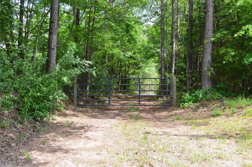 Beautiful private lot with gated gravel driveway. Property has a cleared building site with very private setting.