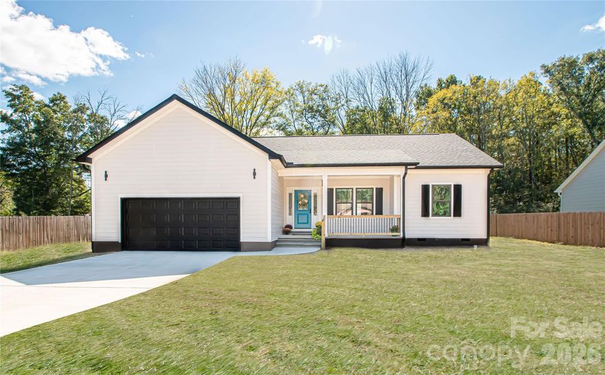 Beautiful new construction ranch home!  Welcome to this stunning 3-bedroom, 2-bath ranch perfectly situated on a flat lot in a quiet and peaceful setting. Step inside to a spacious living room featuring vaulted ceilings and a breathtaking crystal chandelier. The open floor plan flows seamlessly into the kitchen and dining area, creating an inviting space for entertaining and everyday living.  The home features LVP flooring throughout with tile in the bathrooms. The gorgeous kitchen is elegantly designed with white shaker cabinets, black and gold hardware, granite countertops, a stylish tile backsplash, large farmhouse sink, and all stainless steel appliances. A sliding glass door with built-in blinds opens to a deck overlooking the expansive backyard.  The large primary bedroom includes a HUGE walk-in closet and a beautifully designed primary bath with brushed gold accents. Each of the three bedrooms has a ceiling fan/light fixture for added comfort.  Additional highlights include a spacious two-car garage with ample storage, and a private, flat backyard with a deck—perfect for entertaining or relaxing outdoors. Best of all, NO HOA!  Don’t miss the opportunity to own this move-in-ready home that combines style, comfort, and functionality in a serene location.