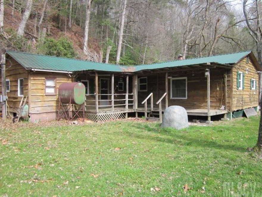 GREAT GET AWAY: With some TLC this is would be a nice weekend retreat. Perfect for the fisherman with Wilson Creek just steps  across the road. House appears to be a single wide with rooms added on. Current owner received property out of estate and does not know condition of heating or cooling source. Property being sold AS IS. There are two monitor heaters in the home but owner thinks there is central air. There  is a community association which which currently  pay no fees.