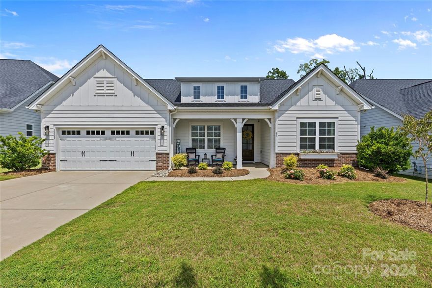 Modern Farmhouse in the charming town of Belmont so close to Charlotte!  Almost 3,000 square ft, it is the epitome of style and comfort, perfect for entertaining. Open floorplan, the kitchen seamlessly flows into the expansive great room. The kitchen features pristine white cabinets, a large island with seating, quartz countertops, stainless steel appliances, and a beautiful marble backsplash in a basketweave design. Great room opens to a wonderful screen porch and stone patio, where you can enjoy the beautifully landscaped backyard. The primary bedroom, conveniently located on the main floor, offers a spacious retreat with a luxurious primary bath featuring an oversized tile shower and double vanities. Wonderful downstairs office, flex space, and guest bedroom. Upstairs, an additional bedroom and versatile bonus area await. Overlake community is the perfect location offering easy access to Stowe Botanical Garden, downtown Belmont, and all the recreational opportunities of Lake Wylie.
