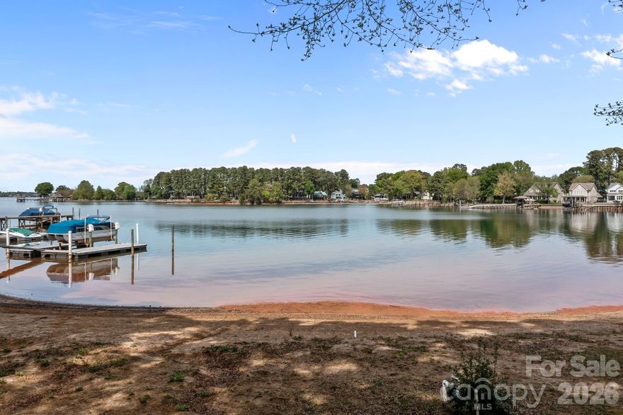 Incredible, vast, waterfront views, from one of the last, pristine lots on LKN. The hallmark of this Modern English Arts & Craft hm has abundance of natural light, showcasing long range views & offers the newest design features. The experience begins w/custom made arched front door & its openness, to the 12’ white oak beamed ceiling @ family/dining rm. Kitchen w/com appliances, quarter sawn white oak island & 12’ ceiling. The primary suite, features private outdoor courtyard that serves as a conduit of light from the bath & bedroom, while maintaining beautiful views. Retire to the lounge w/guests, where the entertainment bar & wine cellar are a key feature. Travel upstairs, via the stair tower, to 3 large en suites w/large views. The upper floor enjoys a library & bonus rm.  No HOA!! Don't miss this rare opportunity to build your dream home on LKN! This home is a proposed floorplan & design, according to specs, adjustments can be made as needed/desired.  Professional photos will be uploaded on April 7 or 8th.