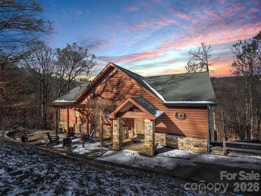 Discover your dream retreat in this beautifully updated home in the heart of Wolf Laurel. Positioned favorably with a direct view of Big Bald Mountain this home features an inviting open floor plan on both levels, highlighted by oak floors on the main level. The spacious kitchen, dining area, and great room create a light-filled, airy atmosphere perfect for gatherings. Two main-level bedroom suites provide comfort and privacy. Most furnishings are included. The kitchen boasts stunning hickory cabinetry, granite countertops, and stainless steel appliances. Gas log fireplaces on each level add warmth and charm to this inviting home.

With a freshly refinished lower level, this property adds outstanding versatility and offers easy year-round access featuring a cozy family room with a wet bar, a third bedroom, a versatile guest/bonus room, a laundry room, and a full bath, along with convenient access to a one-car garage. This level opens directly to a covered lower deck and also includes an exterior entry door, offering a convenient secondary access point.

Step outside to experience two expansive decks equipped with outdoor furniture, effectively extending your living space making this a true highlight of the property.

Nestled within one of Western North Carolina’s most coveted mountain communities, 32 Zebulon Lane offers an unparalleled high-elevation lifestyle. Located near a popular walking route, you’ll also enjoy a convenient distance to the clubhouse, fitness center, and mailboxes. Outdoor enthusiasts can explore an extensive network of hiking and biking trails winding through the resort and adjacent protected wilderness. The excitement continues to grow with the 2026 debut of the Hatley Pointe Adventure Bike Park. From winter skiing at Hatley Pointe to summer rounds at the Wolf Laurel Country Club, recreation is a year-round pursuit. Residents also enjoy the Village Club’s amenities, including tennis, pickleball, a heated pool, and a stocked trout pond—all framed by the breathtaking beauty of the Pisgah National Forest. 

The beautiful furnishings convey with a few exceptions.

Don’t miss out on this exceptional opportunity—make it yours today!