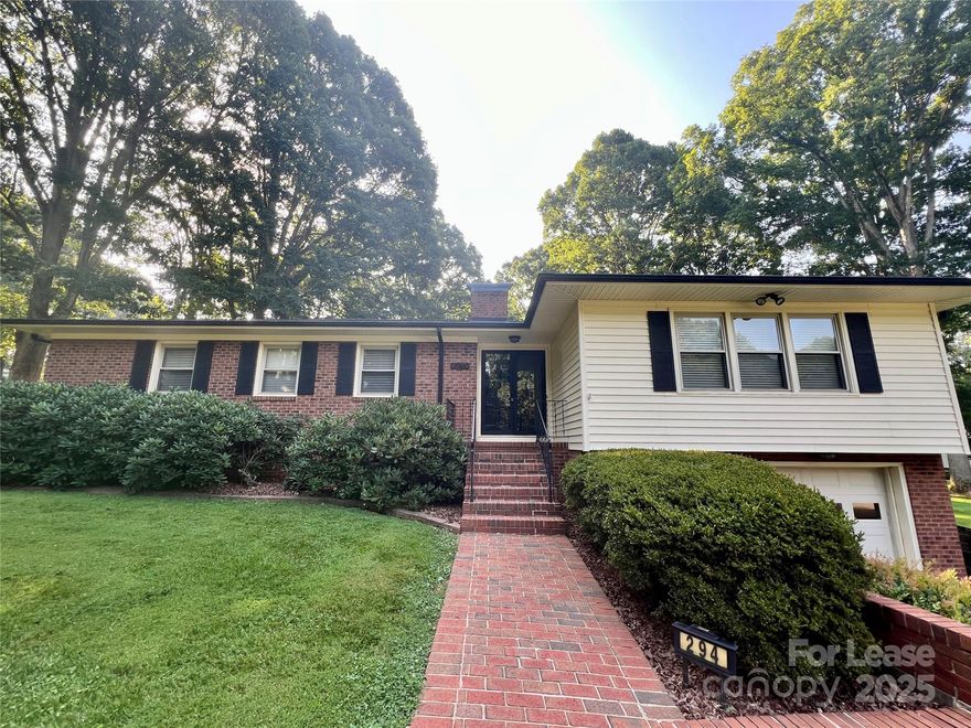 Well maintained Brick RANCH home on over a half-acre corner lot in Troutman! The floor plan has a large Living and Dining area, Great Room open to the Kitchen that has an eating bar with stools (to remain) and new vinyl plank flooring. Laundry Room has Washer/Dryer, and there are 2 Bedrooms that share a Full Bath with new vinyl flooring. The Primary Bedroom Suite is at the end of the hall with an Ensuite Bathroom. The large basement is unfinished and is to be used for storage only. Enjoy a large rear Deck and beautiful mature trees and landscaping. Ample parking in the driveway and 1-Car Garage. Tenant is responsible for all utilities, lawn maintenance, and garbage pickup. Tenant will be responsible for maintaining 100 gallons of oil in the backup oil tank. Items stored in the basement need to be in plastic totes or on pallets & no storage is allowed in the attic. The central vacuum is functional and will not be repaired or replaced. No Smoking and No Pets are allowed. AVAILABLE NOW!