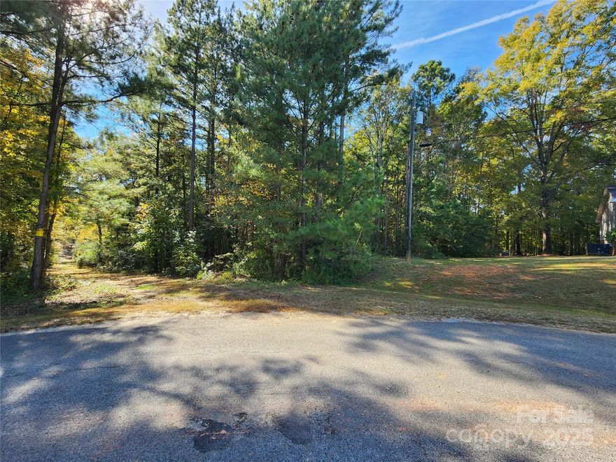 1+ acre building lot in an established neighborhood with water and sewer in Lancaster SC just minutes from Lancaster's schools, shopping and downtown. This unique lot presents a rare opportunity for developers, investors, or those looking to build their new home. The parcel is on the corner of Old Greenbriar Drive and fronts an unbuilt road and it has a sewer easement going through the lot for easy connection. The upper portion of the lot should be suitable for a new home and the remainder of the lot offers wooded privacy. The listed address is not assigned and is used for location purposes only. Don't miss your chance to transform this lot into something truly special.