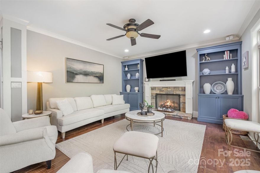 PRICE REDUCED TO SELL! Waterfront/water view 3 level home in Mt Isle Harbor on Mountain Island Lake. Main level boasts an open, spacious plan featuring hardwood floors, a great room w/built-ins & gas fireplace & a dining room w/coffered ceiling. Luxury kitchen w/island seating, double ovens, bright breakfast area plus a screened-in back porch & expansive deck overlooking wooded privacy & partial lake views. Upper level has 3 bedrooms plus the primary en-suite. Primary bath has heated flooring & includes both a garden tub & tiled shower, double vanity, bidet & custom closet. The fully finished basement includes another gas fireplace, full bath, a versatile flex room plus tons more space for working out or playing. Enjoy outdoor living on the ground-level patio with a private path leading to the lake. This home offers a harmonious blend of luxury, comfort, and lakeside living, making it an exceptional choice for discerning buyers seeking a tranquil lifestyle. Easy drive to Charlotte.