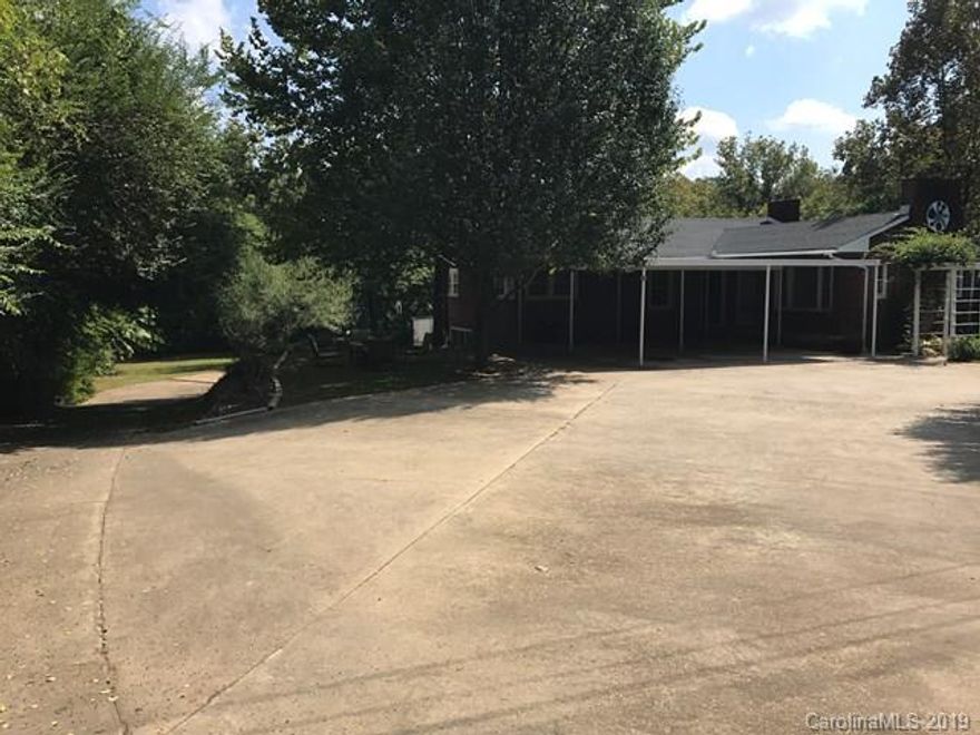 This beautiful 3 bed 1 bath brick ranch home sits on 3 lots just outside of city limits. The home has original hardwood floors throughout with several updates to the living room, kitchen and the bathroom, enjoy the morning with the added sun room. The home also has 2 separate driveways, one that leads to the garage around back and another that leads you to the front of the home and continues to the back of the house as well. At the back of the house you will see the huge shed that is attached to the house and accessed from outside or through the basement.perfectly located 1.8 miles from downtown, less then half mile to the hospital, senior center,doctors offices, green way, restaurants and 1 mile from Wal-Mart, and interstate 40.