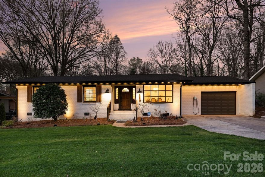 This beautifully renovated brick ranch in the desirable McClintock Woods offers 3 spacious bedrooms, 2 updated baths, and 1,619 sqft of inviting living space. Nestled on a 0.386-acre lot, this home is perfect for those seeking modern comfort and convenience. As you step inside, you’ll be greeted by gleaming hardwood floors, an open-concept living area filled with natural light, and a stylish kitchen featuring a large island, granite countertops, tile backsplash, stainless steel appliances, and a gas range. The dining area, with a charming bay window, overlooks the private, flat backyard, while the sunroom offers additional flexible space for a home office or cozy lounge. The serene primary suite includes a refreshed en-suite bath with a tiled shower and contemporary finishes. Two generously sized secondary bedrooms share a beautifully updated bath. A convenient mud/laundry room connects to the attached 1-car garage. Enjoy outdoor living with a spacious, expansive patio and a meticulously manicured lawn perfect for entertaining. Recent updates include a new roof & HVAC units in 2021, a new water heater in 2022, and new plumbing under the house in 2023. Just 10 minutes to downtown Charlotte, South Park, and Matthews, this home offers the perfect blend of comfort, convenience, and location.
