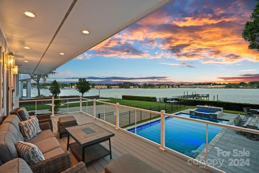 If views & lake life are what you're after, look no further! Enjoy the outdoor experience with pool, outdoor kitchen, expansive deck, & a dock with boat lift to complement the property's 140-feet of shoreline on the main channel of Lake Norman! The home's expansive front porch welcomes you & your guests, followed by the sunlit open floor plan. With views from several rooms in the house, enjoy the beautiful skyline - sunrise, sunset, or an exciting thunderstorm - from the comfort of your home. The main level, ideal for entertaining, features the primary bedroom with 2 ensuite bathrooms. Upper level offers a media room & four additional spacious bedrooms; one with an ensuite, two with shared Jack & Jill, & one additional full bathroom. When you're ready for some indoor fun, the finished basement was designed with entertaining in mind. Currently with a pool table, foosball, & air hockey, open the garage doors to invite the outside in. For wine enthusiasts - enjoy stocking the wine cellar!